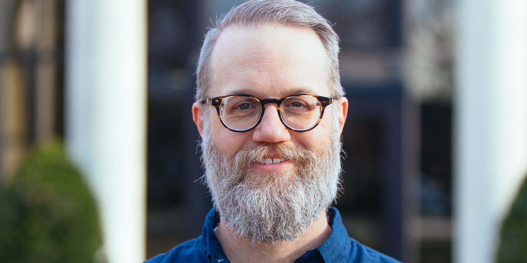 Photograph of man with beard and eyeglasses.